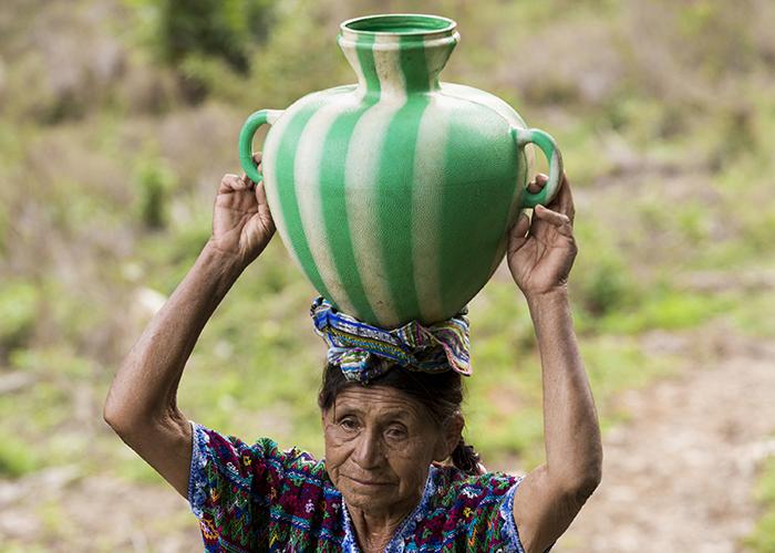 Woman carrying a water container
