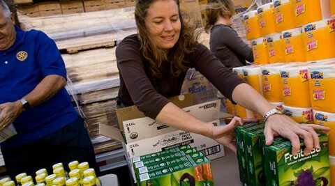 Volunteers organizing food and supplies for a community distribution